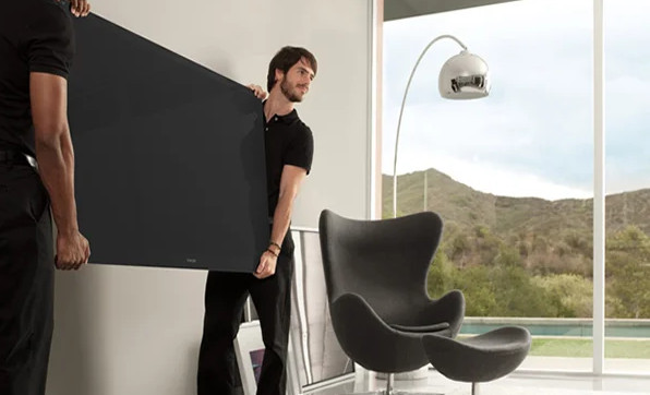 Two technicians hanging a TV.