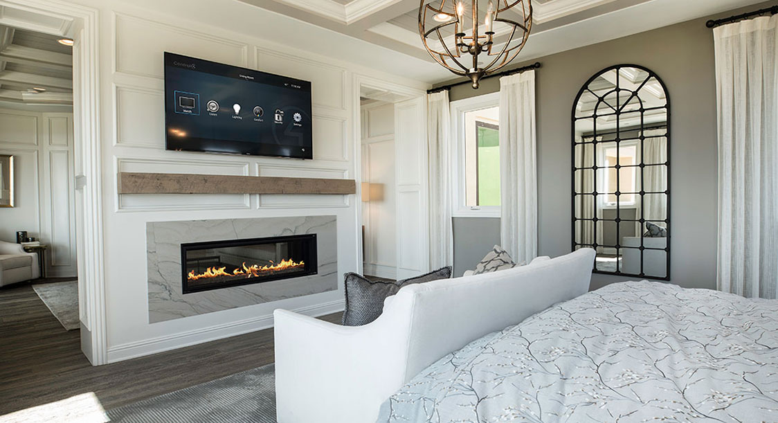 Living room with TV mounted over a fireplace.